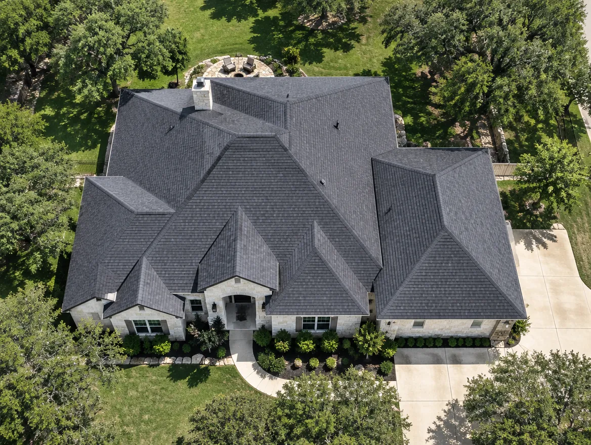 Straight-down view of a Central Texas home with a complex hip-and-valley charcoal shingle roof