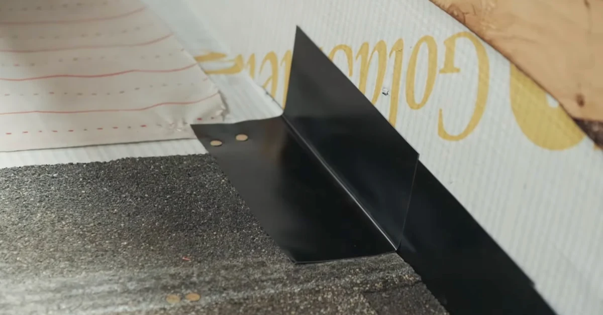 IKO installation example: metal step flashing at a shingle roof-to-wall junction